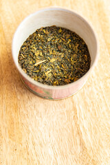 green tea dried petals flavored tea sprinkled to prepare a hot drink fresh portion healthy meal food diet snack on the table copy space food background rustic top view