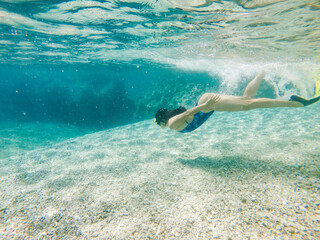 sexy woman swimming underwater in diving mask with flippers