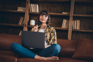 Full body photo of thinking millennial bang hairdo lady sit type laptop do shopping wear shirt jeans bare foot home indoors alone
