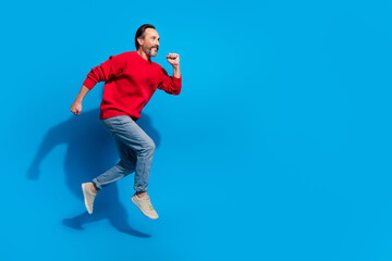 Fototapeta na wymiar Full size profile side photo of funky good mood man running traveling enjoy holiday isolated on blue color background