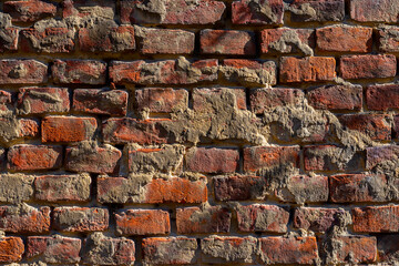 Red brick wall. Horizontal rows of old bricks. Textured surface. Broken wall.