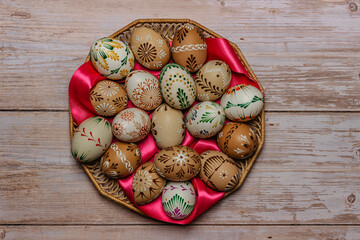Colorful Easter Eggs and ribbons banner.Above view with copy space for text.Happy Easter decoration background,hand painted decorated eggs.Spring festive symbols.Holiday Still life photo.DIY product