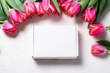 Carton, cardboard box decorated with spring fresh tulip