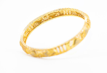 gold jewelry bracelet over on white background