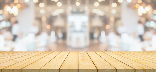 Empty wood table top with cafe restaurant interior blurred background