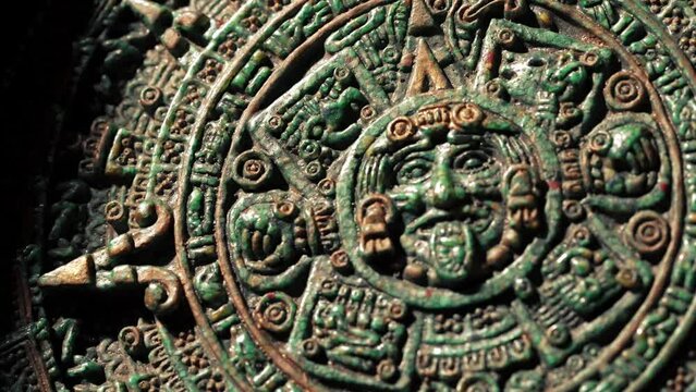 Close-up slow motion camera panning around an old Mayan calendar