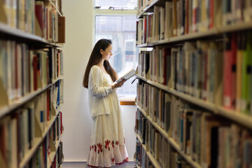 asian stylish young university school lady research student read book in library