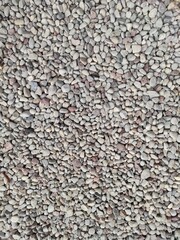 Full frame natural background of light colored small pebbles 