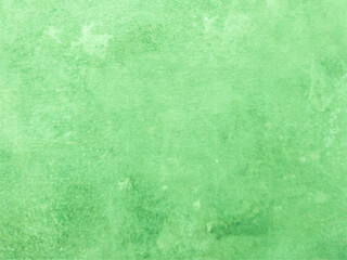 The smooth concrete wall is green with spots. Green background with texture. Worn surface.
