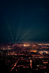Panoramic view of the city of Barcelona at night with rays of light