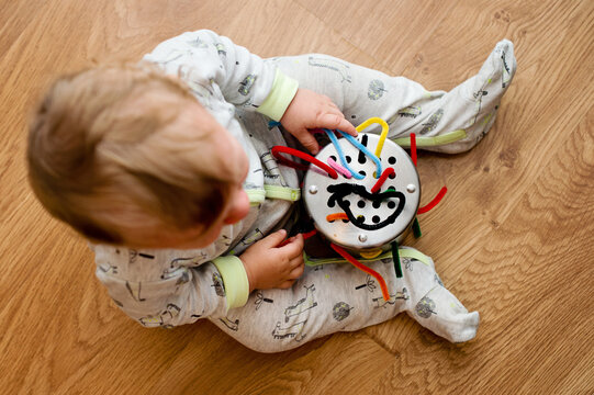 Little Baby Boy Playing. Develops Fine Motor Skills Of Hands.