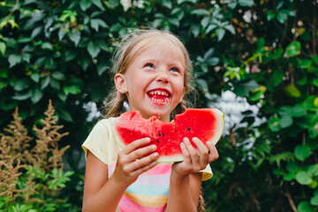 Happy funny girl eats watermelon outdoor. Summertime