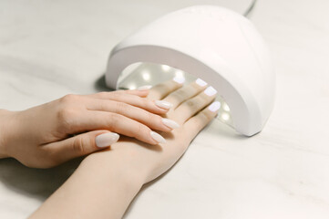 Master performing a professional manicure at beauty salon, on-line manicure training course. Nail beauty blogging. Selective focus, nail design