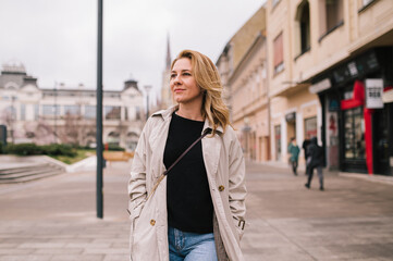 Beautiful woman walks down the street and enjoys her day off.