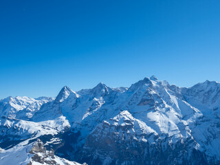 Winter view from Schilthorn peak, Switzerland, towards the famous mountains Eiger, Moench, and Jungfrau