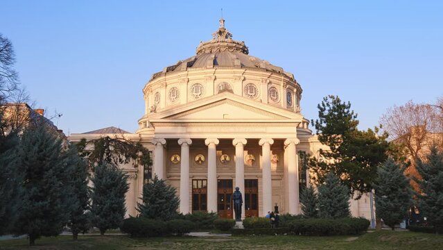 Romanian Athenaeum, a landmark in Bucharest, Romania. Hyperlapse of shadows across the neoclassical ornated facade of this domed, circular building, opened in 1888.