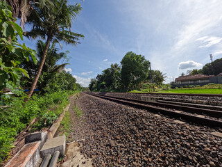 Fototapeta na wymiar The view of the rail road in Yogyakarta Indonesia, visible rocks and a clear sky background