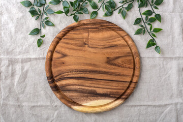 Wood plate, board for pizza on linen tablecloth background