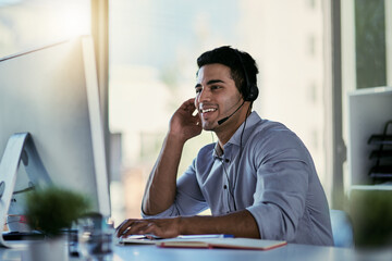 He knows just how to solve your problem. Cropped shot of a call centre agent working in an office.