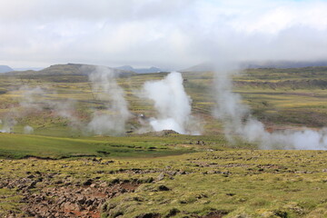 Outdoor adventure in beautiful and dramatic volcanic landscape, steaming fumaroles (horizontal), Hveragerdi, Iceland