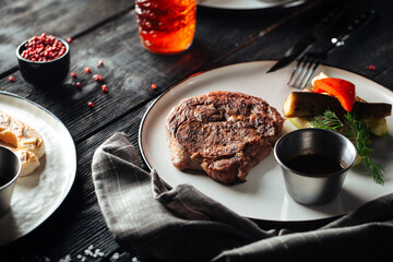 Grilled beef steak with pepper sauce and vegetable garnish