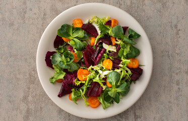 Warm salad with mixed salad with boiled carrots and beetroot with spices