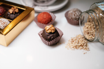 Box of homemade sweets on white background. Several sweet candies on white table.