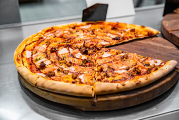 sliced bbq pizza on sale in a shop window.