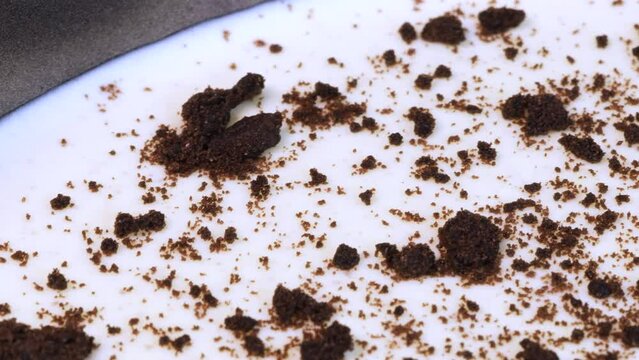 Macro shot of homemade chocolate and cream cheese cake into a metal pot, rotating. Close up view.