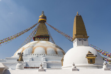 Low angle shot of the white Buddhist monument Boudhanath Stupa in Kathmandu