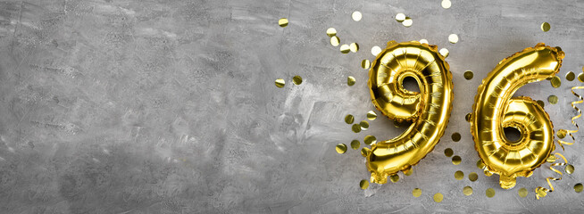 Yellow foil balloon number, number ninety-six on a concrete background. Greeting card with the inscription 96. Anniversary concept. for anniversary, birthday, new year celebration. banner,