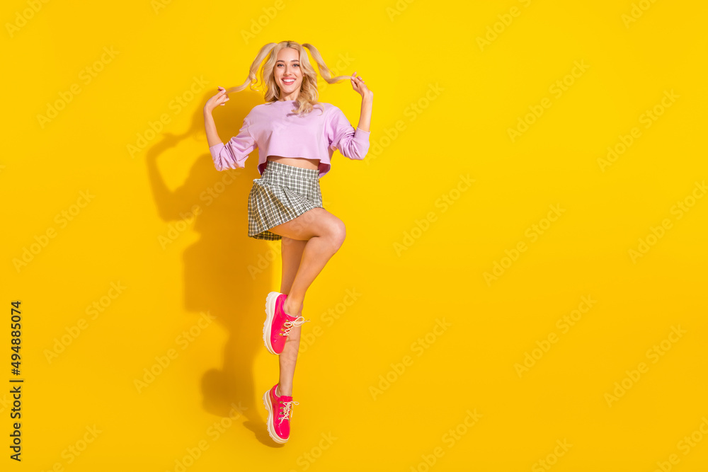 Sticker full length photo of pretty satisfied girl hands hold play hair tails isolated on yellow color backg