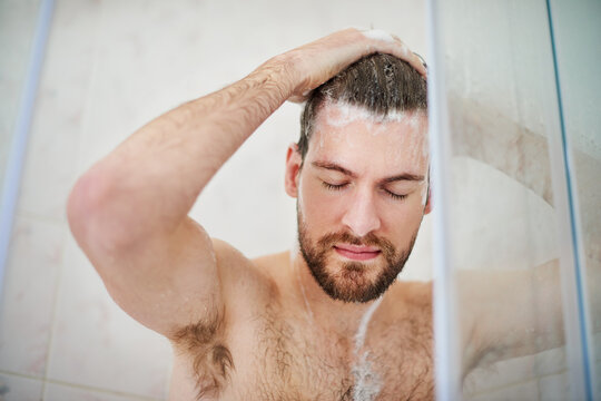 Start your day on a refreshing note. Cropped shot of a handsome young man having a shower at home.