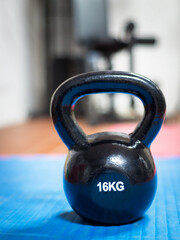 Naklejka na ściany i meble 16 kg kettlebell at a gym. Weight lifting concept.