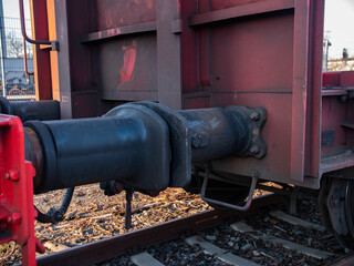 Close-up of buffers between wagons. Freight station for cargo, transportation and logistics of...