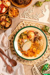 Lontong sayur or vegetable rice cake is an Indonesian traditional rice dish made of pieces of lontong served in coconut milk soup with shredded chayote, tempeh, tofu, hard-boiled egg, sambal, rendang