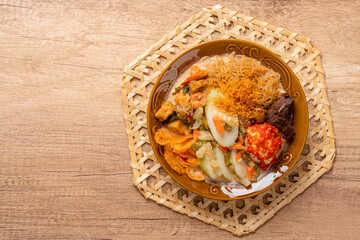 Lontong sayur or vegetable rice cake is an Indonesian traditional rice dish made of pieces of...