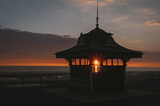 Beautiful sunset shining through a structure on the Blackpool shore