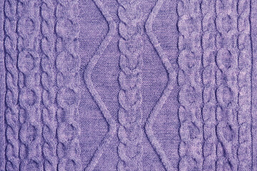 Textured lilac knitted surface in color 2022.Beautiful handmade knitted background with a pattern...