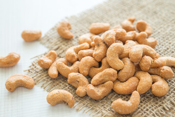 Salted cashew nuts on sackcloth. Food cuisine concept.