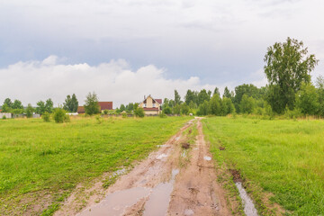 Blurred dirt road to houses