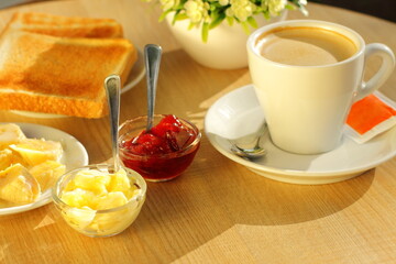 Toasted bread, butter and cup of coffee for breakfast