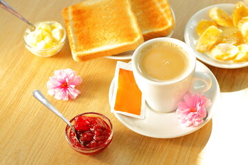 Toasted bread, butter and cup of coffee for breakfast