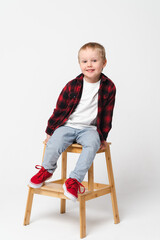 Portrait of a little smiling boy on white plain background - preschool kid
