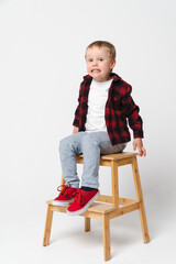 Portrait of a little frightened boy on white plain background - preschool kid