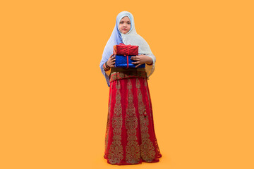 Full length of islamic Child girl in hijab holding Gift box