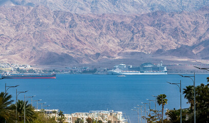 Luxury cruise oceanic ship moored in the port of Aqaba, Jordan. View from Eilat city, Israel 