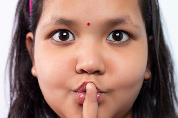 Close Up Of girl With Finger On Lips