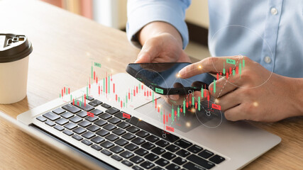Businessmen work with stock market investments using laptop to analyze trading data. smartphone with stock exchange graph on screen. Financial stock market.