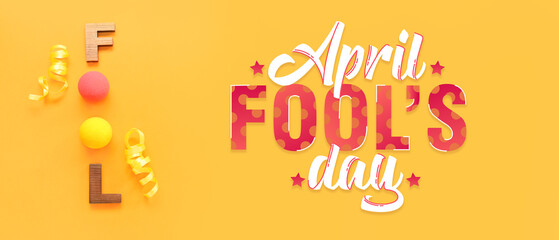 Word FOOL made of clown noses, letters and confetti on orange background. April Fools Day celebration